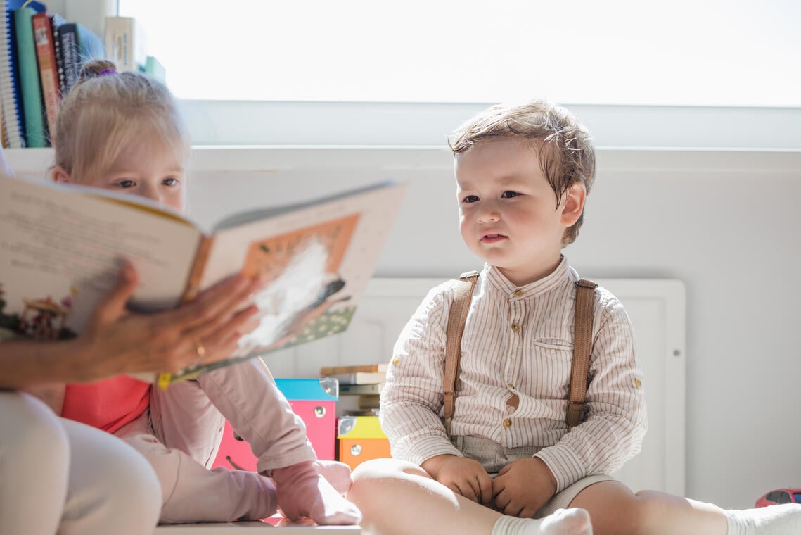 children-sitting-looking-book.jpg