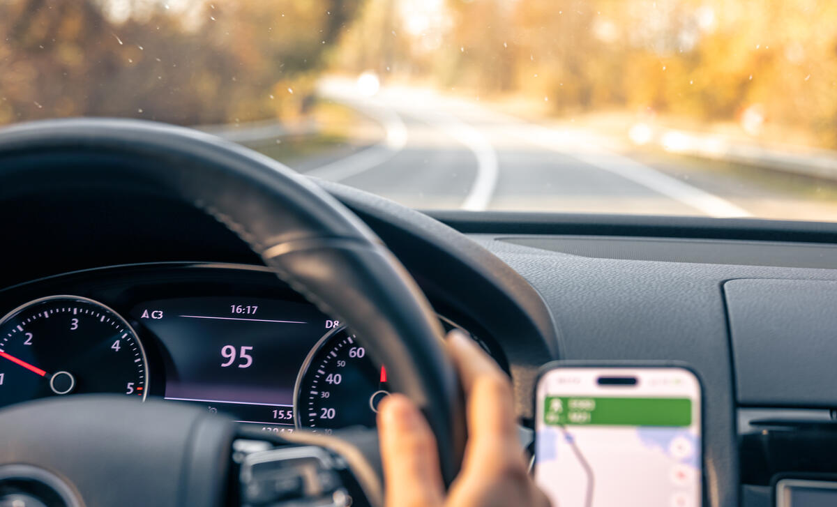 steering-wheel-car-close-up-high-speed-driving-road.jpg