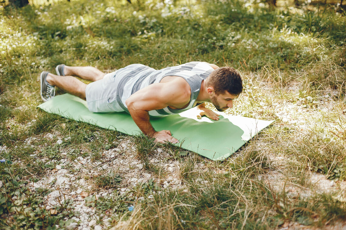 Sports man in a morning summer park