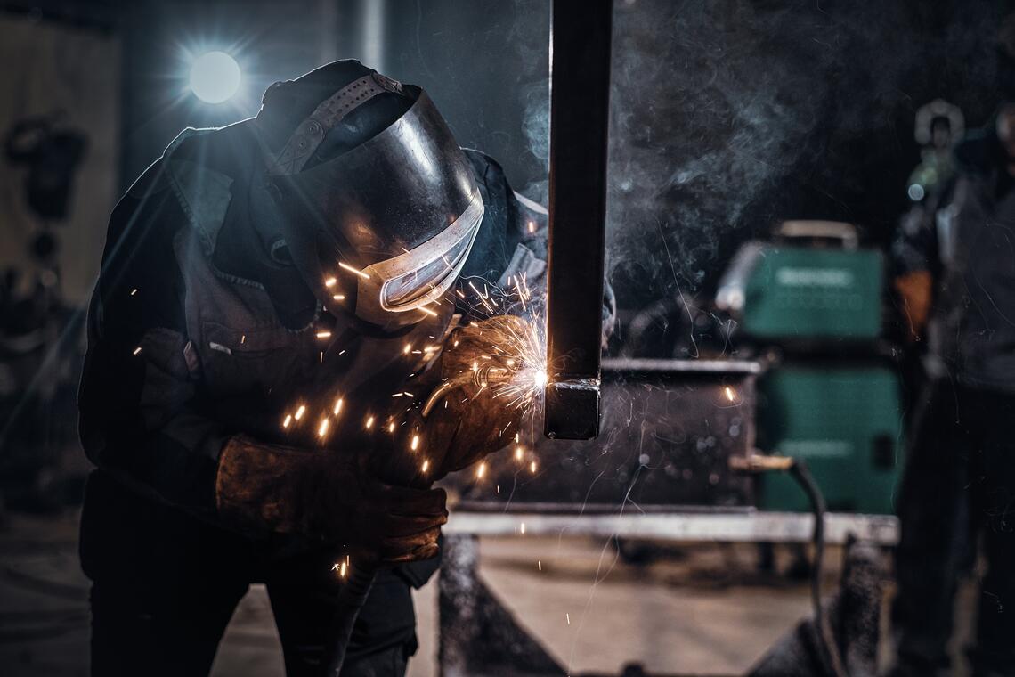 Man is working at the busy metal factory