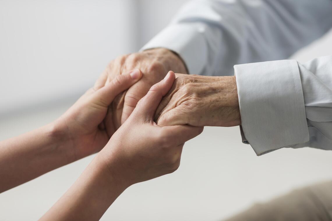 nurse-holding-senior-man-s-hands-sympathy