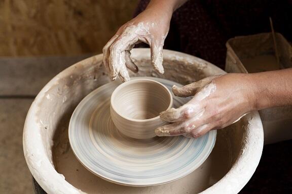 hands-modeling-in-clay-on-potter-s-wheel.jpg