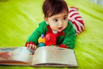 The small girl looking at book