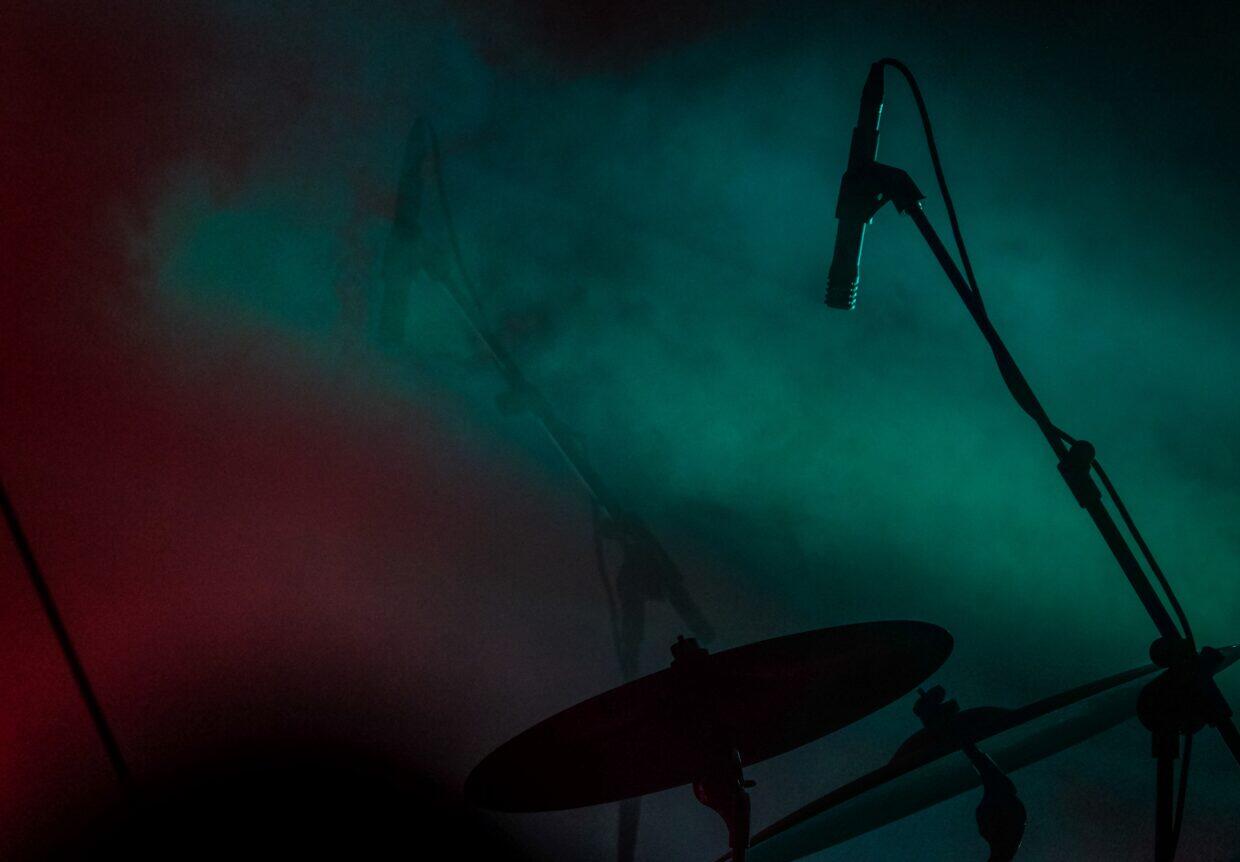 close-shot-of-microphone-near-the-drum-with-smoke-1240x862