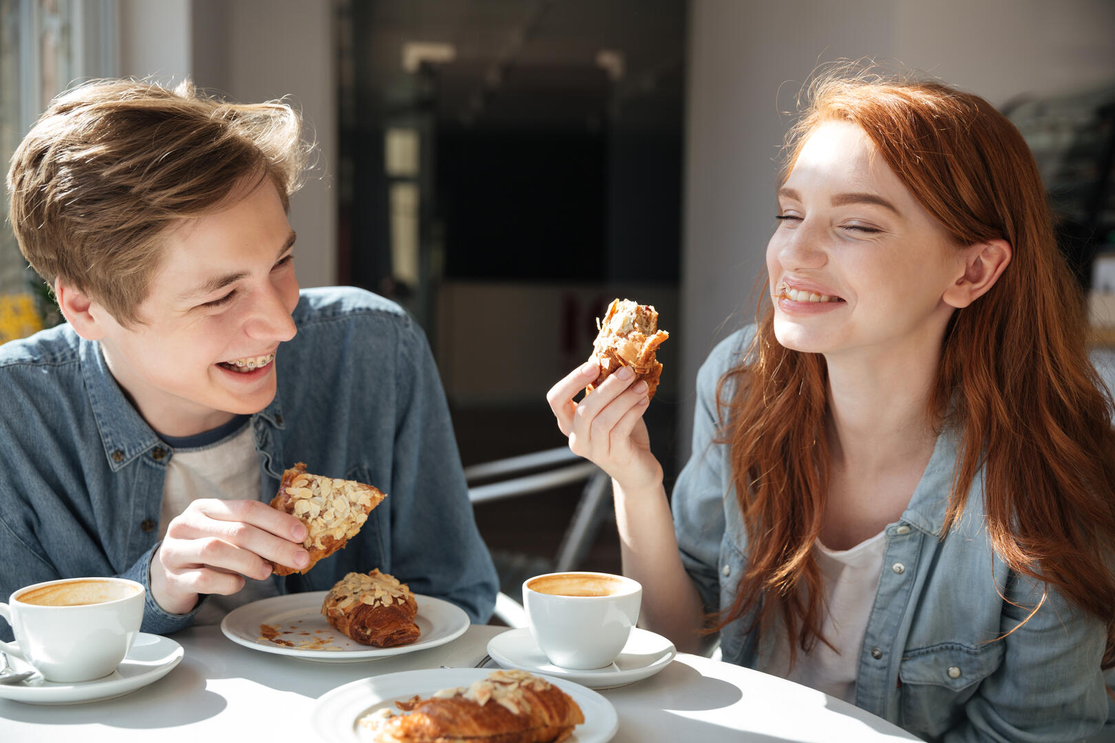 Pretty couple eating in cafe
