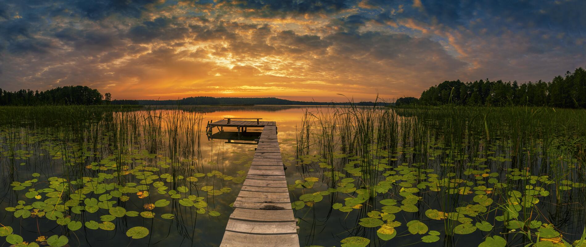 Panorama of beautiful sunrise over lake