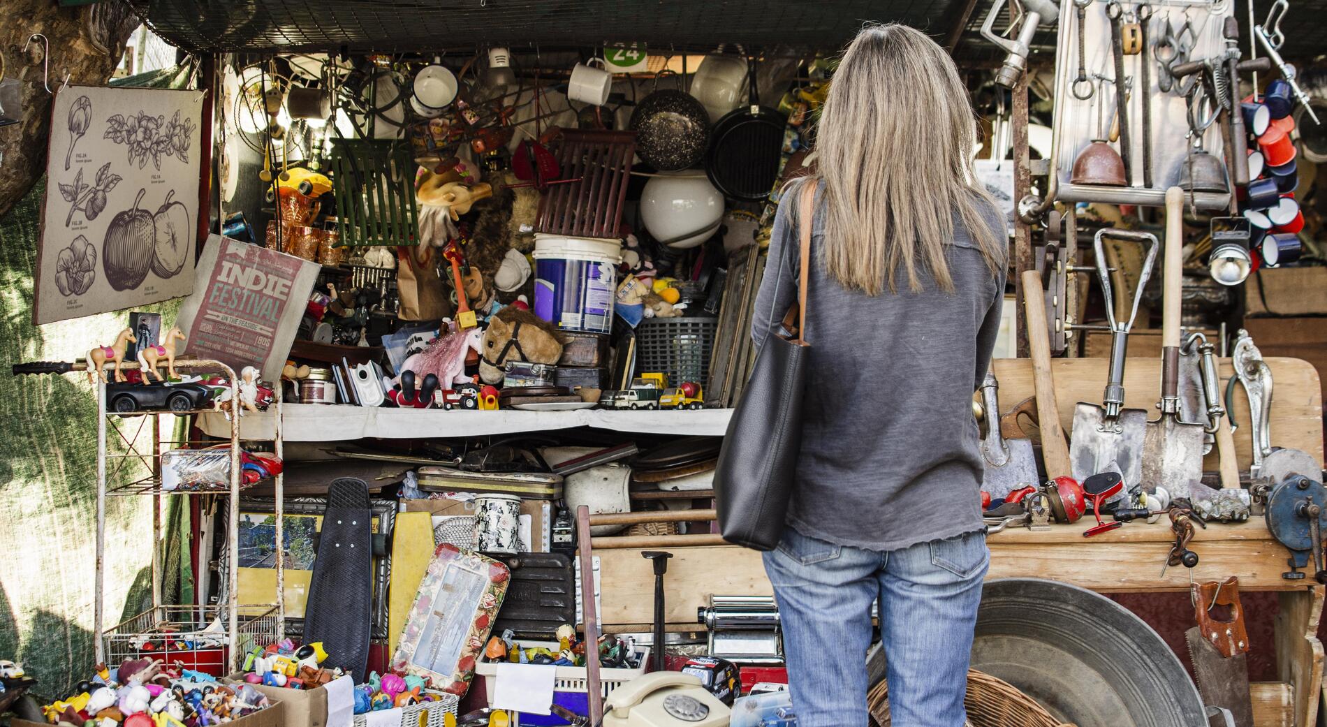 woman-searching-something-buy-antiques-market