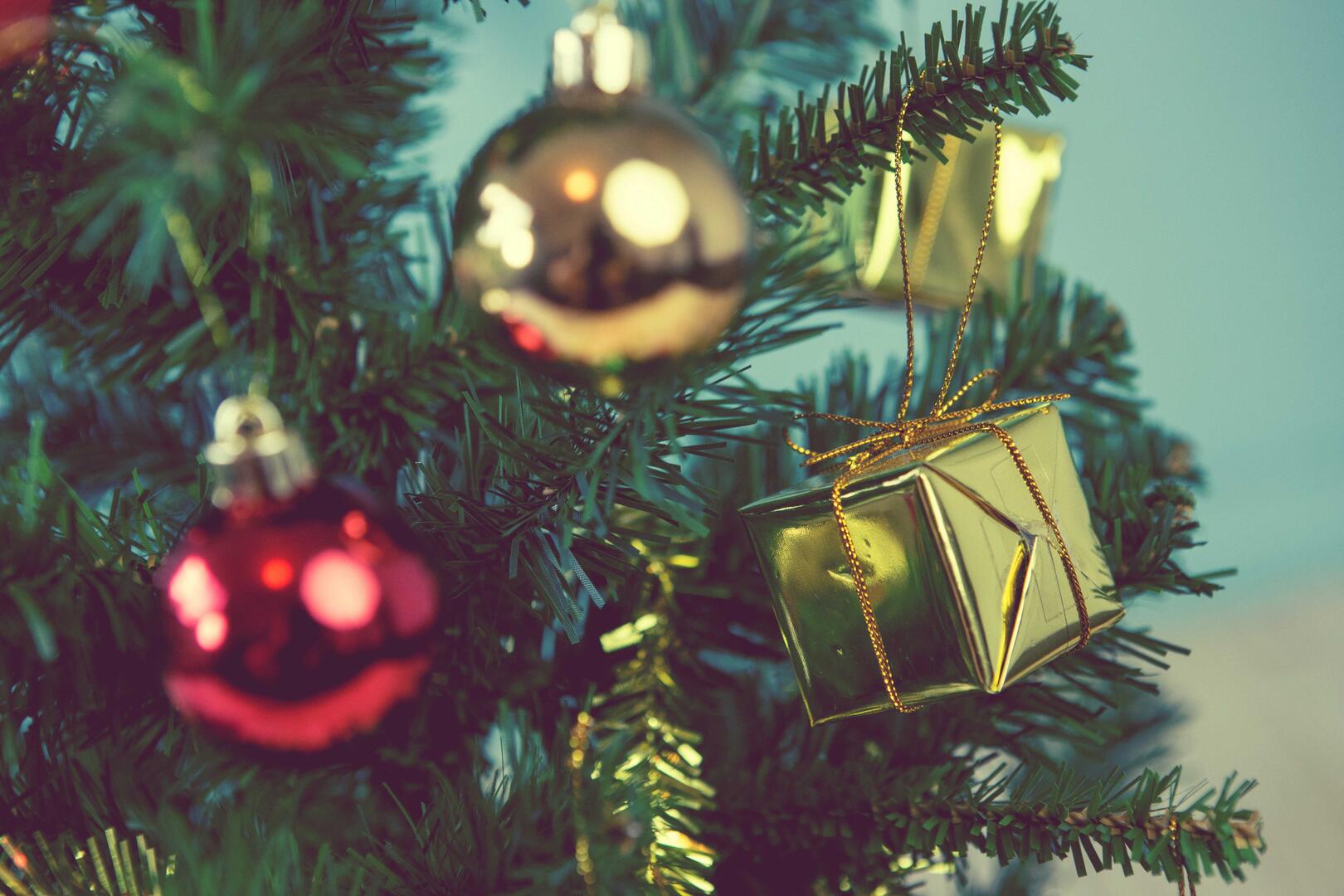 Christmas tree with gifts on green background on blurred, vintage color style