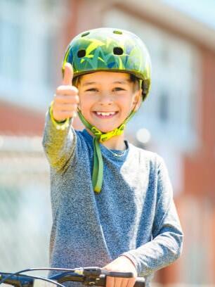 A child having fun outdoors driving bike for children on playground