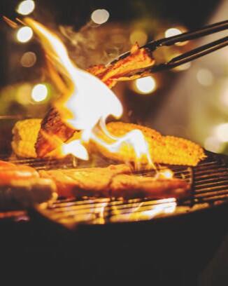 Family making barbecue in dinner party camping at night