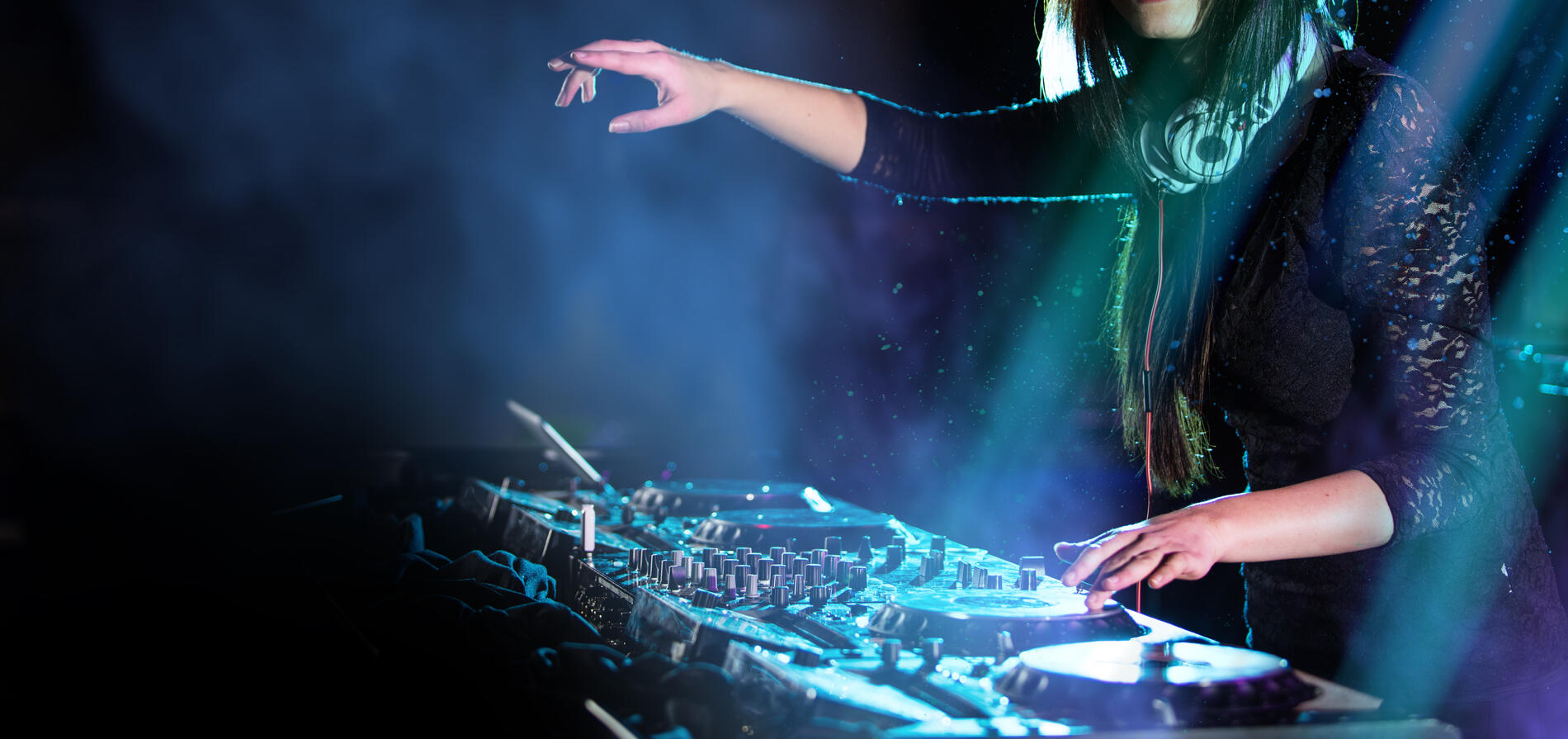 Dj mixes the track in the nightclub at a party