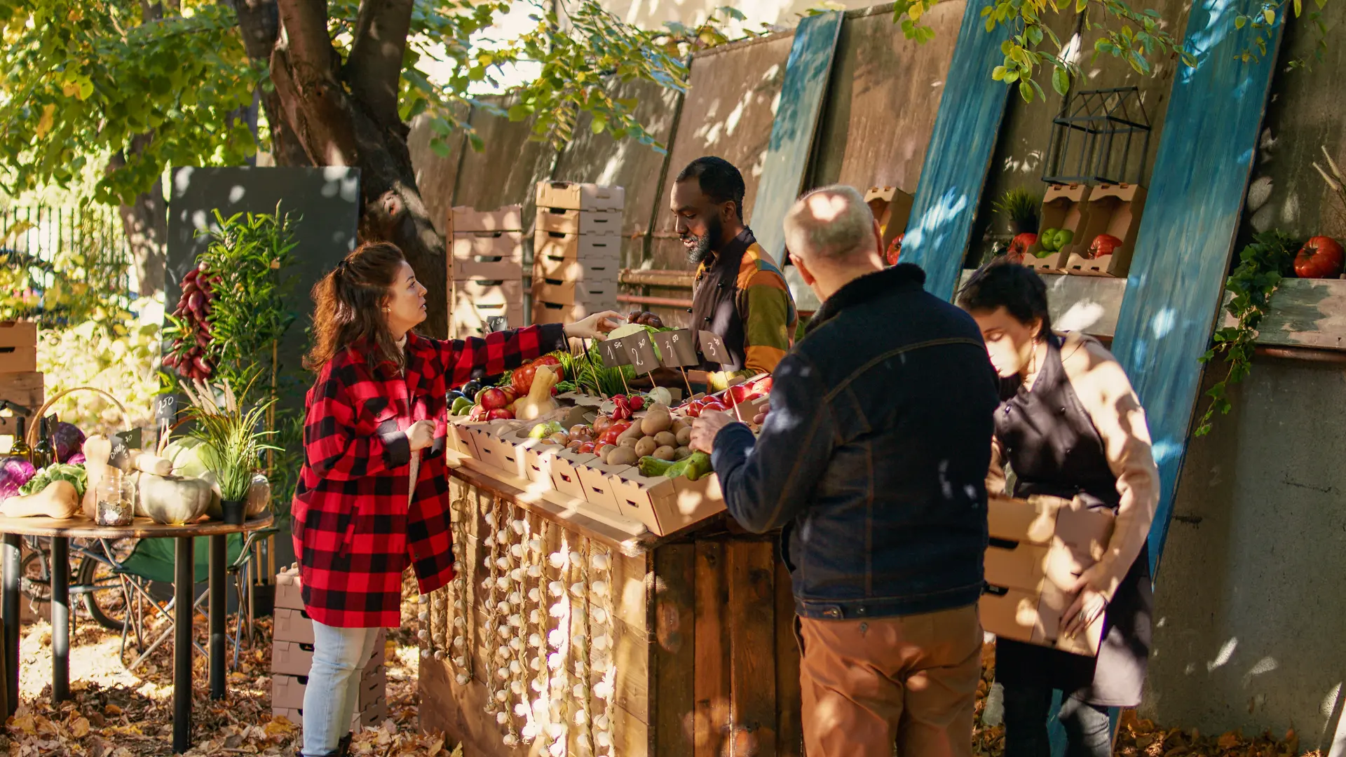 Young farmer serving client with various produce