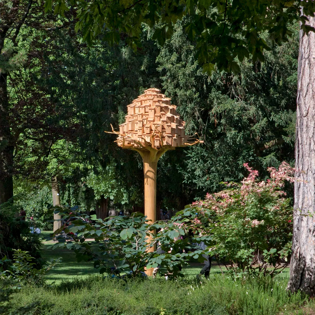 Tronc et souche d'épicea planté dans le parc surmonté d'une sorte de pigeonnier