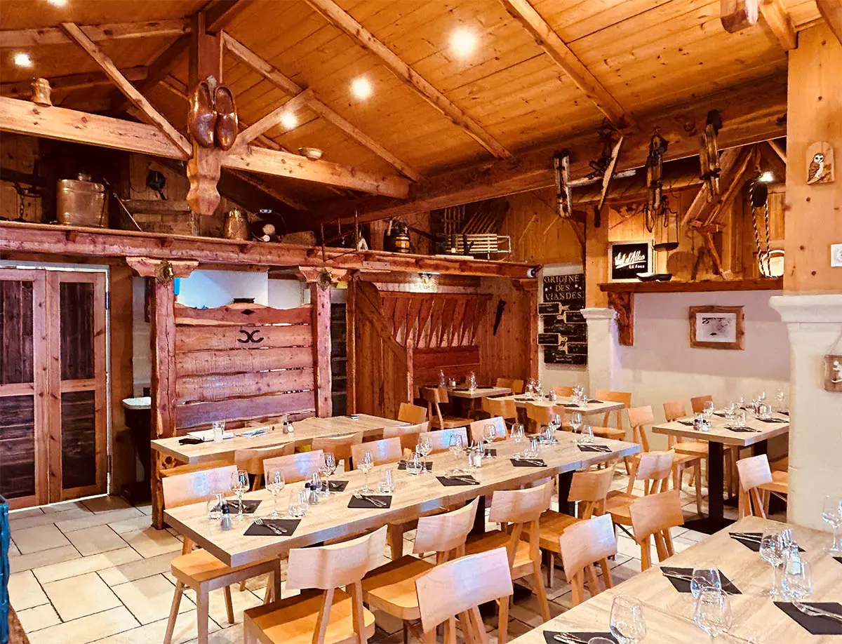 Restaurant dining room, wooden tables and chairs, interior decoration and wooden roof, warm atmosphere