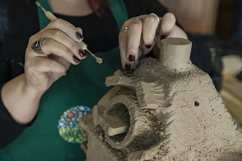 Master using clay and making a sculpture
