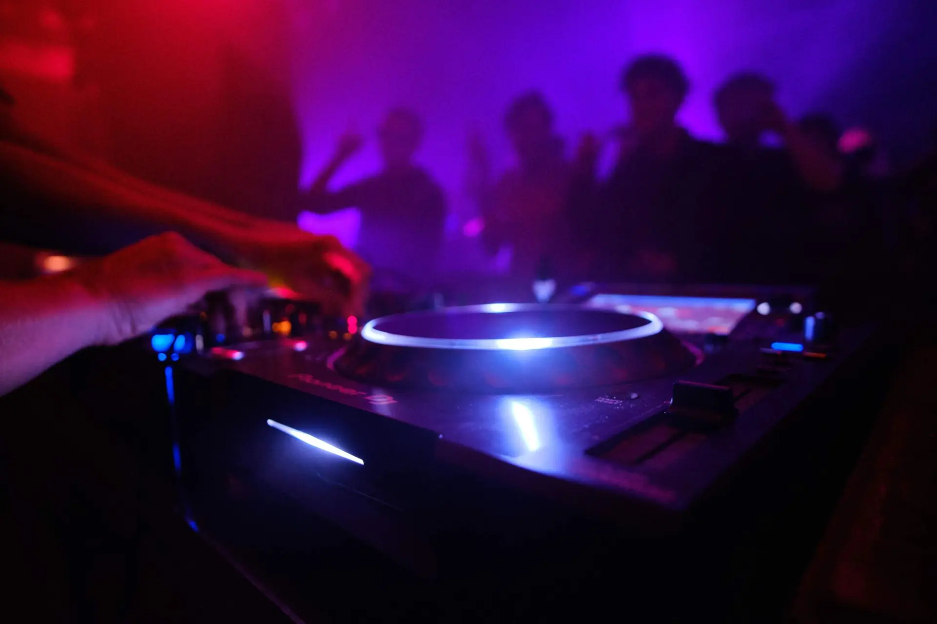 closeup-shot-dj-s-equipment-people-dancing-club