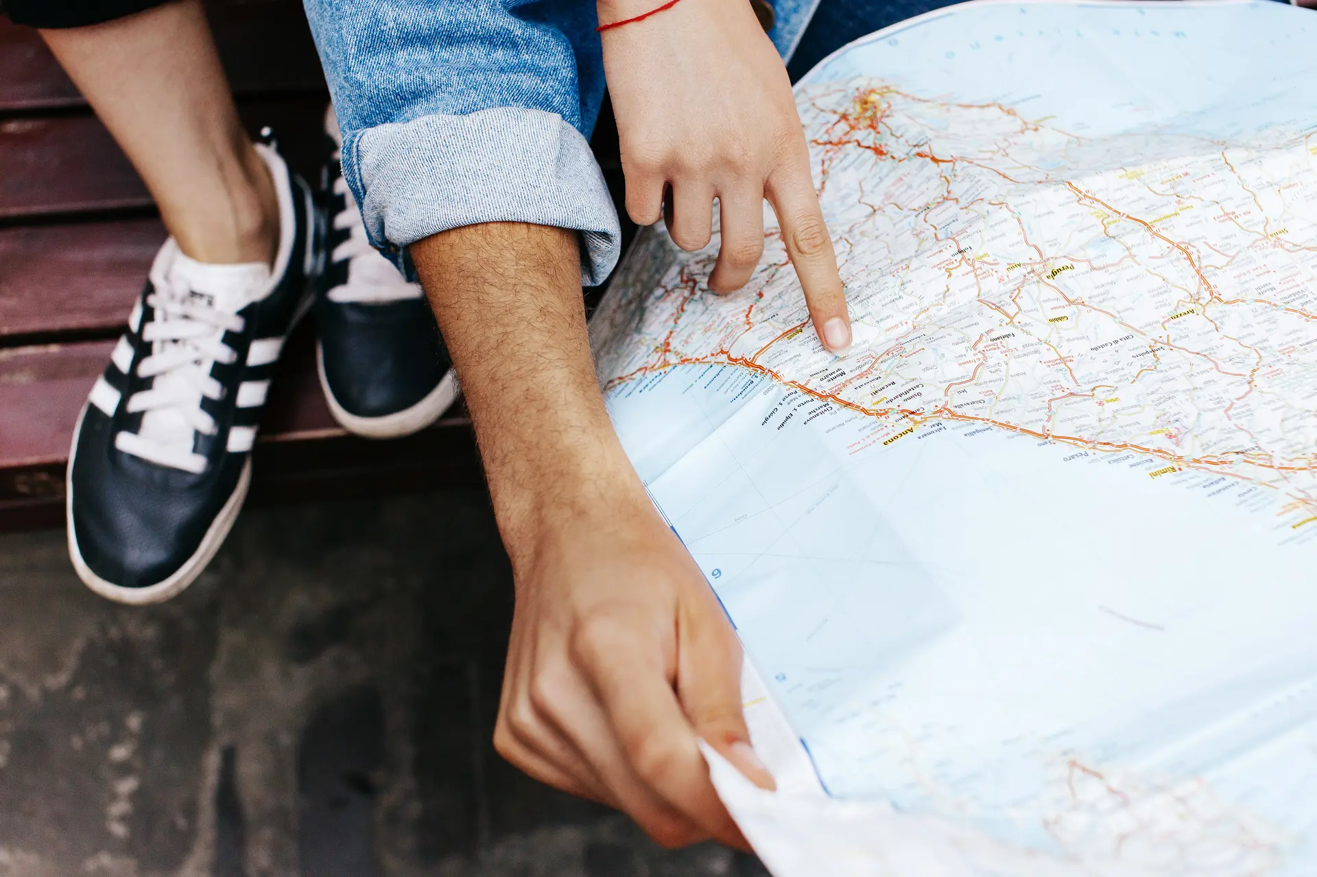 Hands of young couple on touristic map