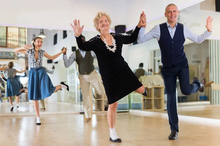 Mature woman dancing swing with young man
