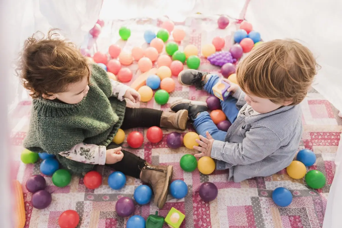 high-angle-view-kids-sitting-inside-tepee