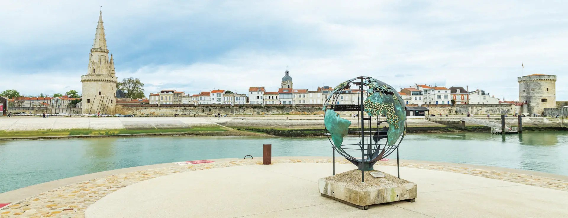 Globe of La Francophonie and the Lantern Tower on Saint Jean d'Acre Square in the Old Port of La Rochelle, France