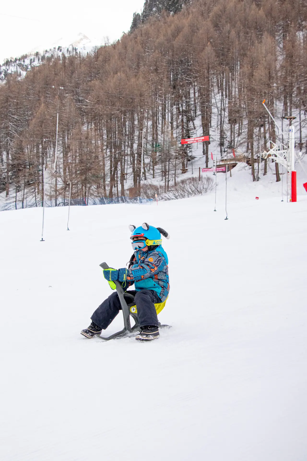 Enfant sur un Yooner à Val d'Isère en hiver sur la piste de la Savonnette