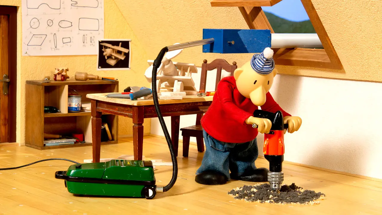 peronnage d'un film d'animation qui utilise un marteau piqueur dans une maison pour faire un trou