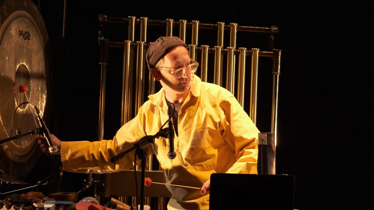 artiste sur scène avec une blouse jaune