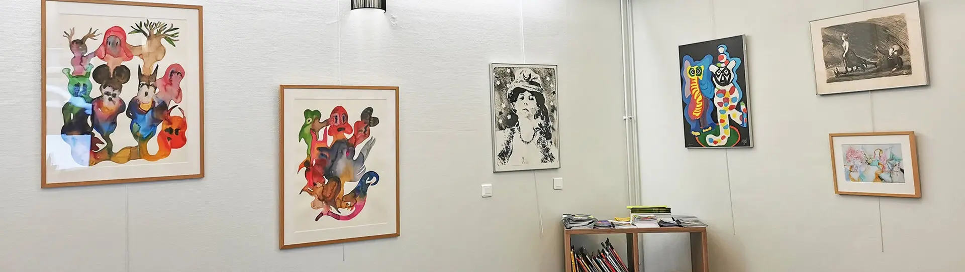 Ensemble de tableaux sur un mur blanc