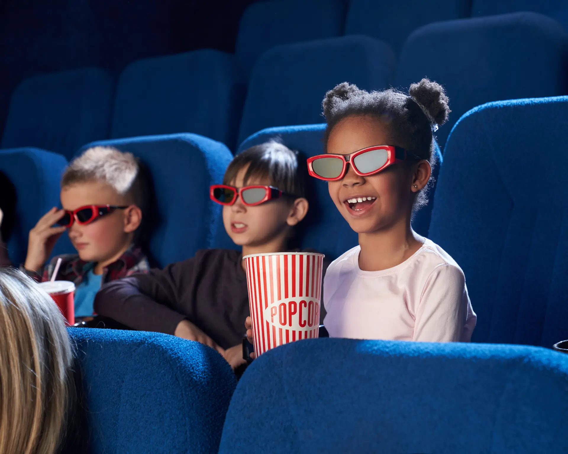 3 enfants dans une salle de cinéma