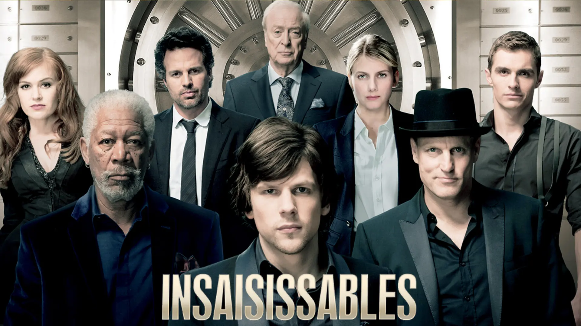 A movie poster showing a group of seven people in dark suits in front of a large vault. The title NOW YOU SEE ME is written in large letters at the bottom of the image.