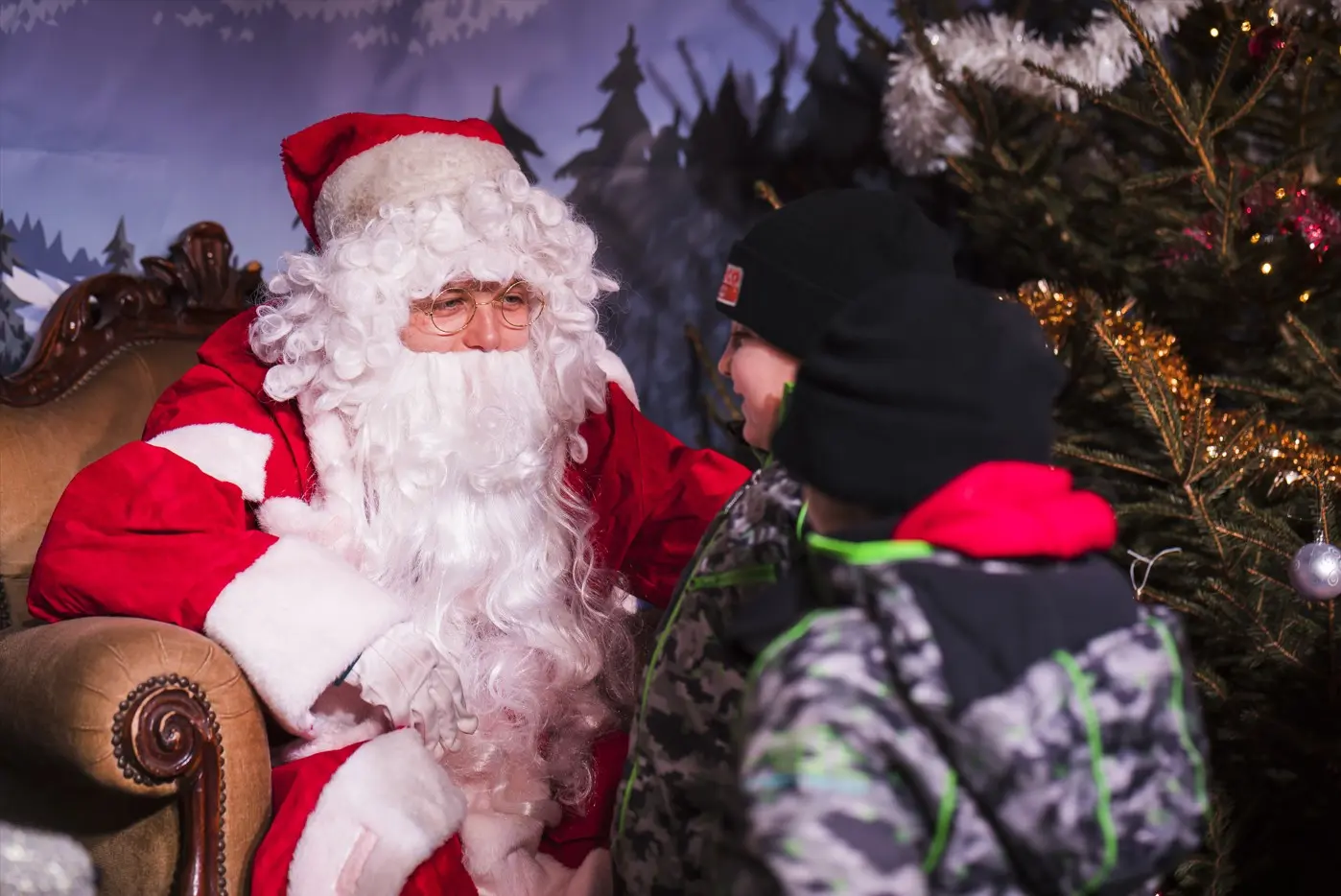Père noel faisant face à deux enfants