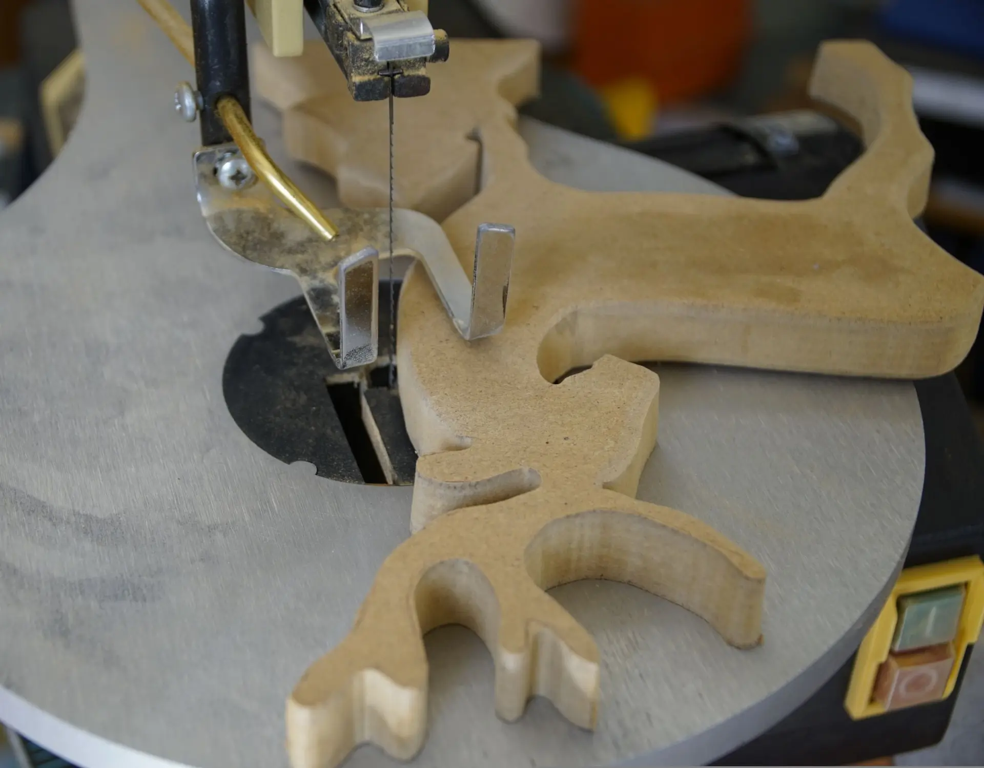 scroll saw with reindeer-shaped piece of wood