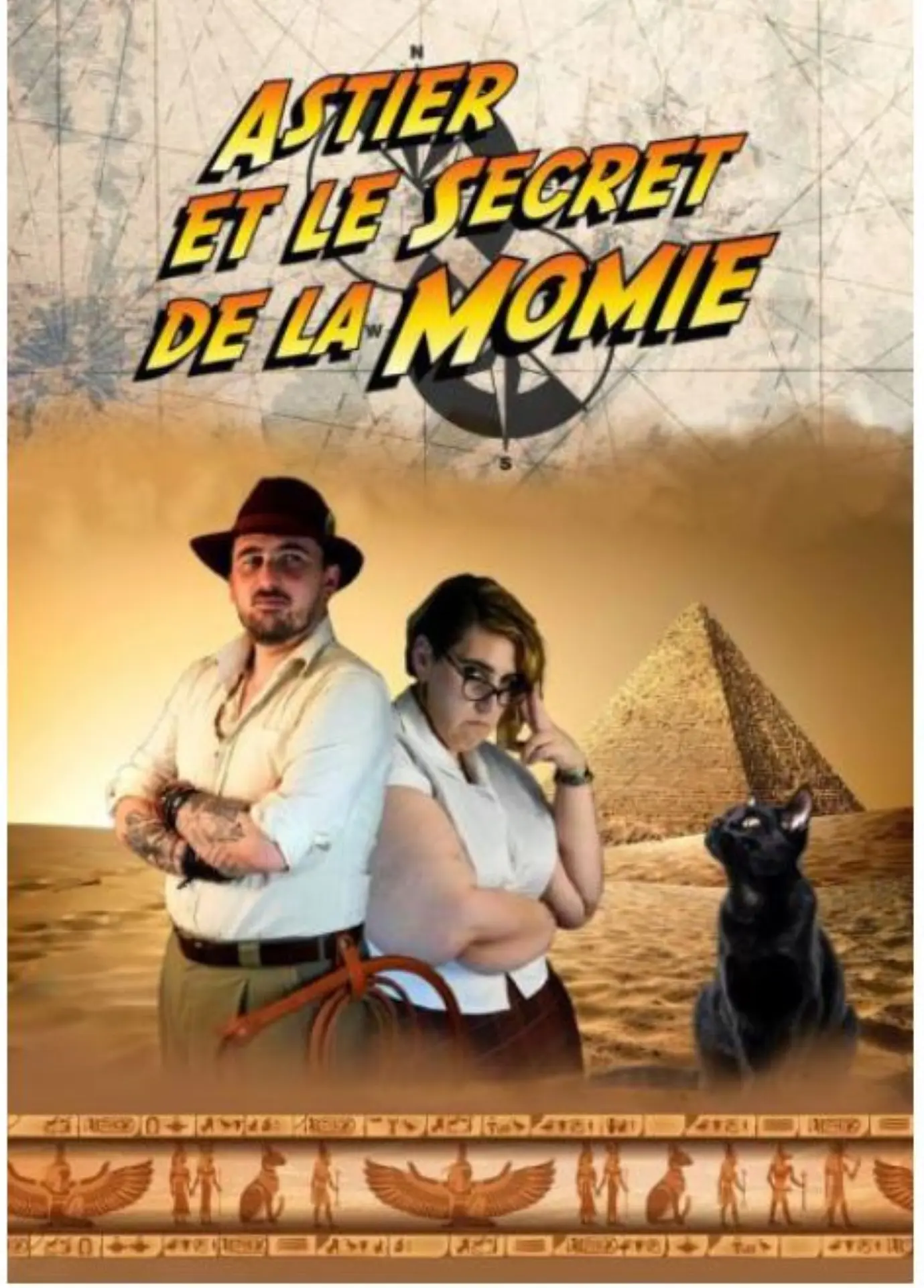 Astier et son assistante sont avec un chat noir devant une pyramide.