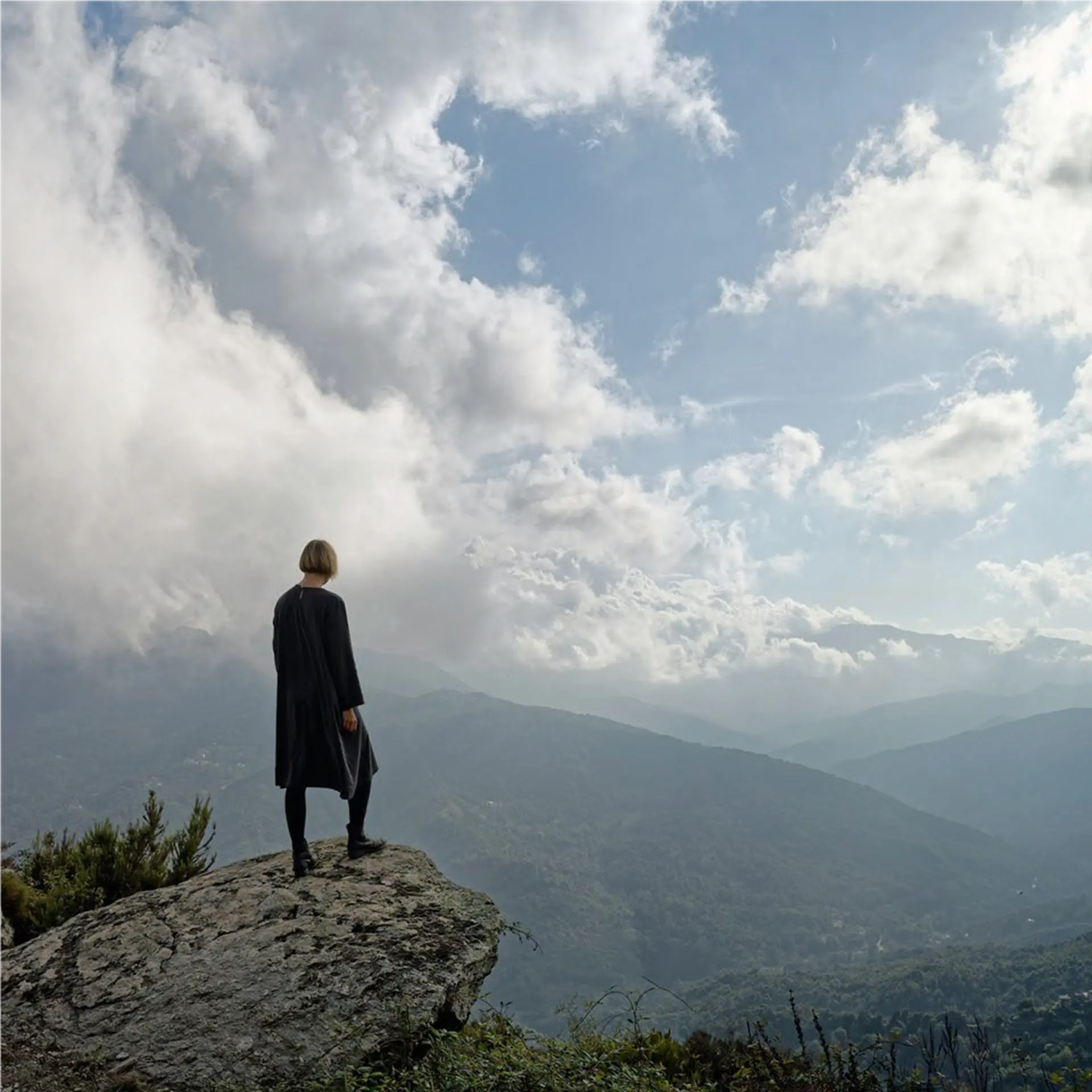 Photographie d'une femme face à des montagnes