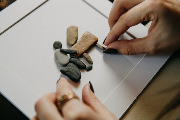 Stone figures embedded to the blank paper