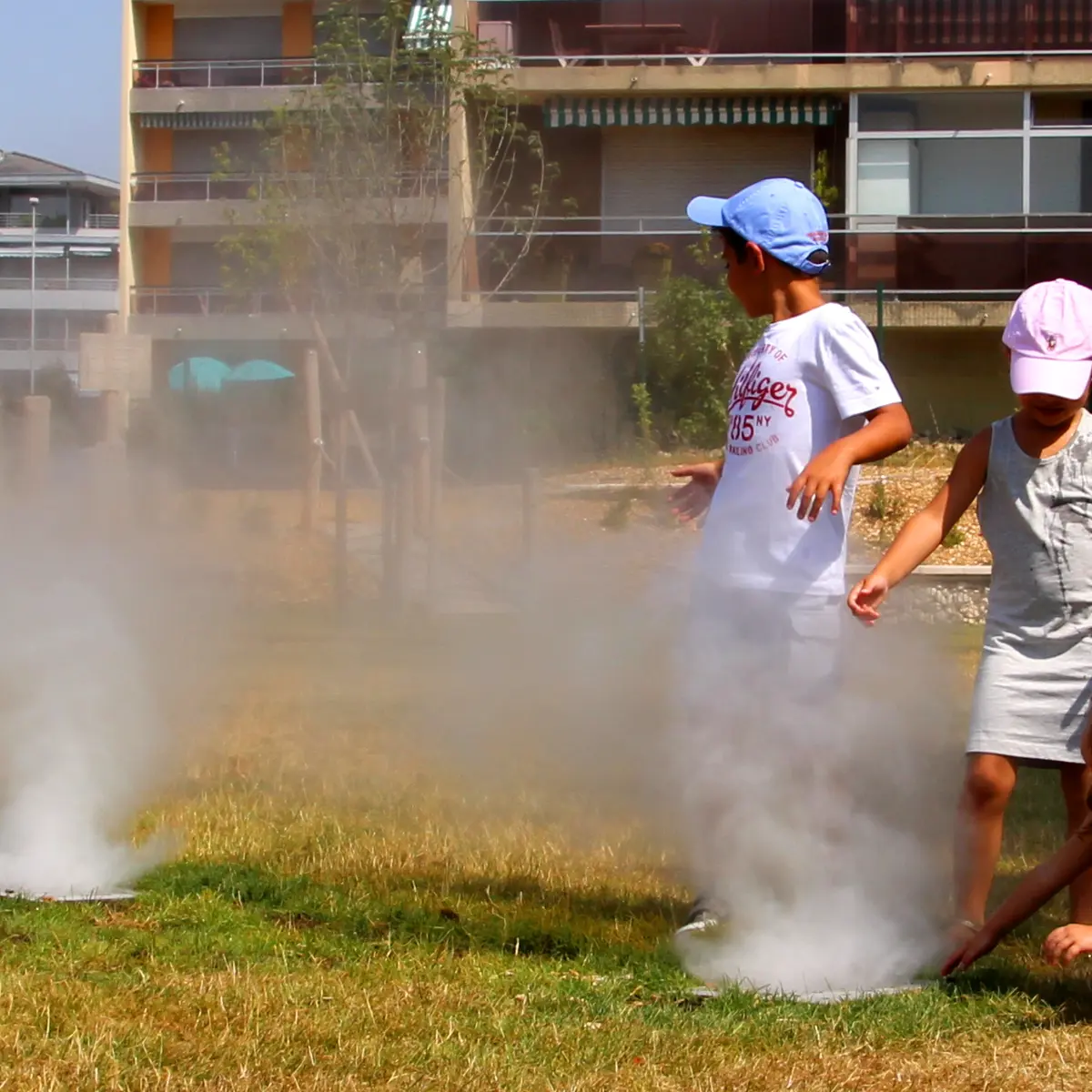 Enfants jouant sous les brumisateurs