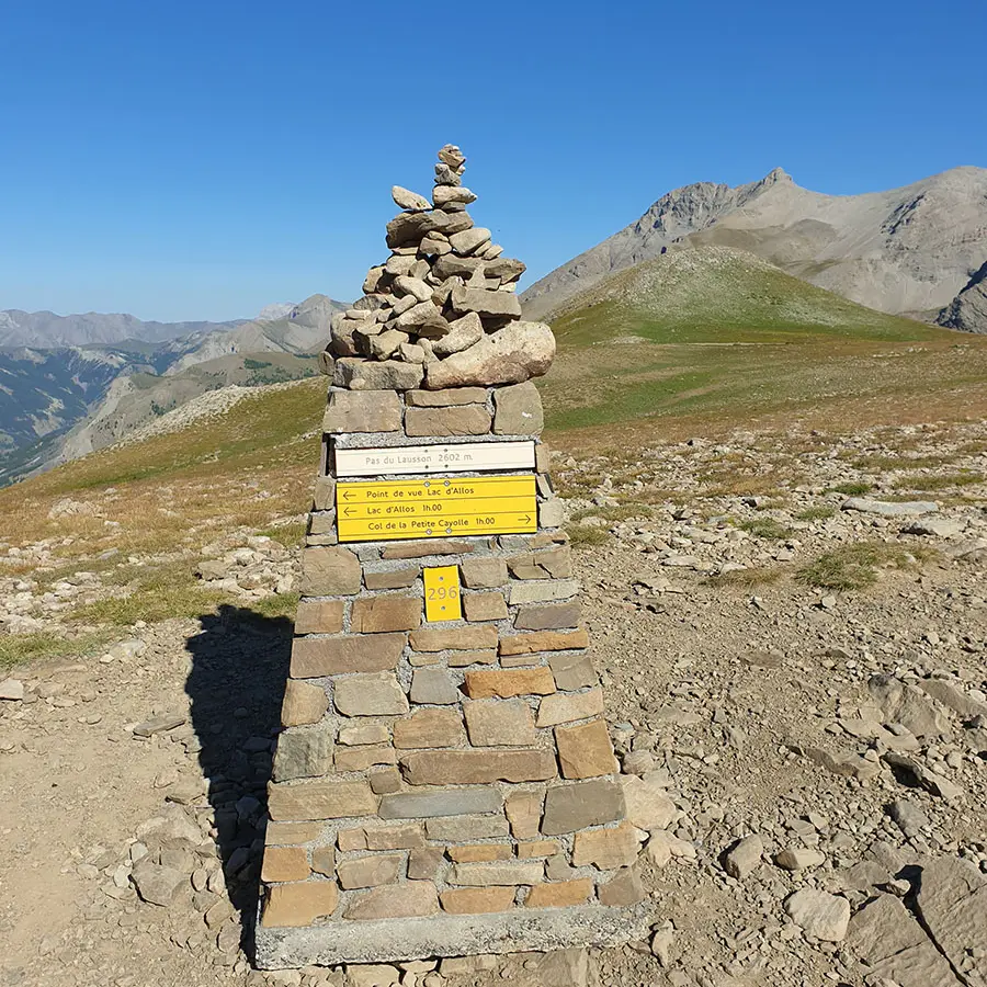 Stone marker at Pas du Lausson, 2,602 m, situated on a promontory and indicating several directions