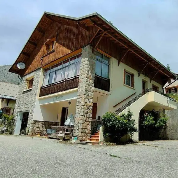 Chalet with stone facade and glass balcony