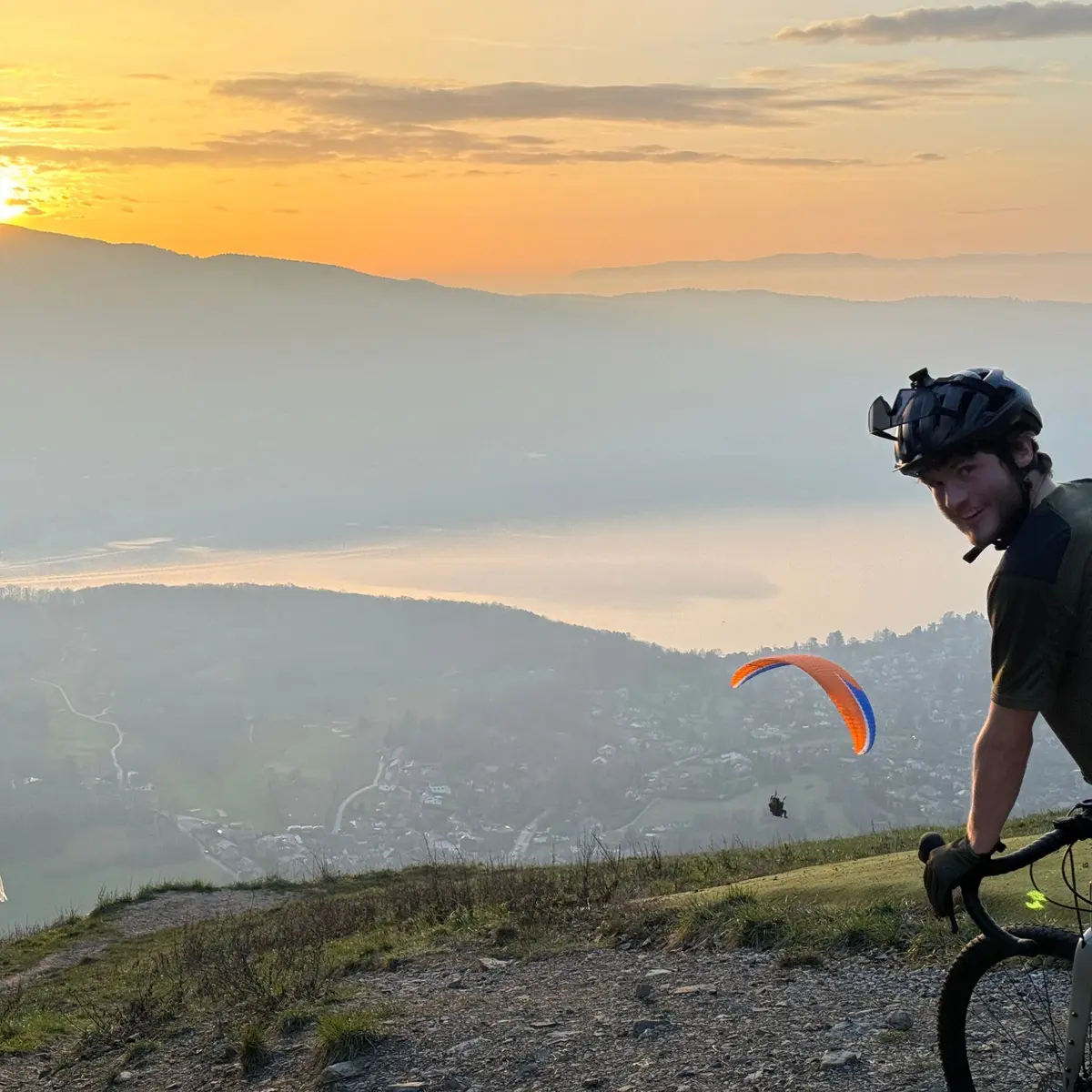 cyclist at Col de la Forclaz view of lake Annecy