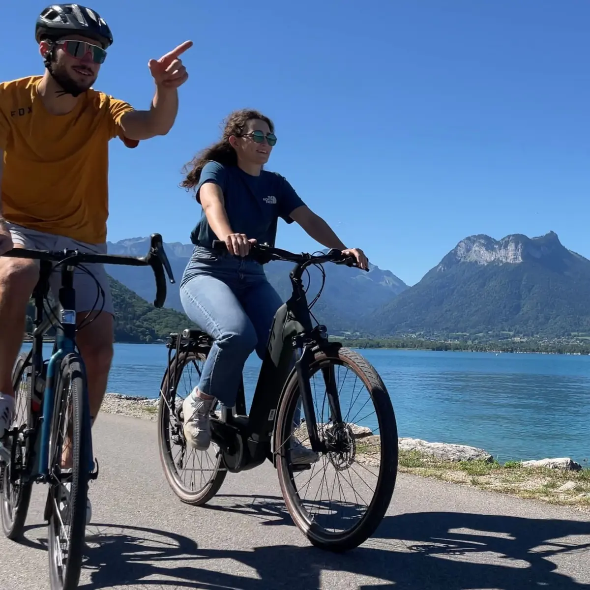 couple cycling by lake Annecy