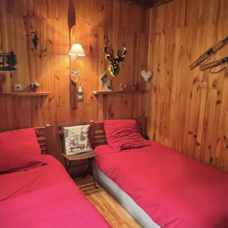 Bedroom with two single beds, wooden interior