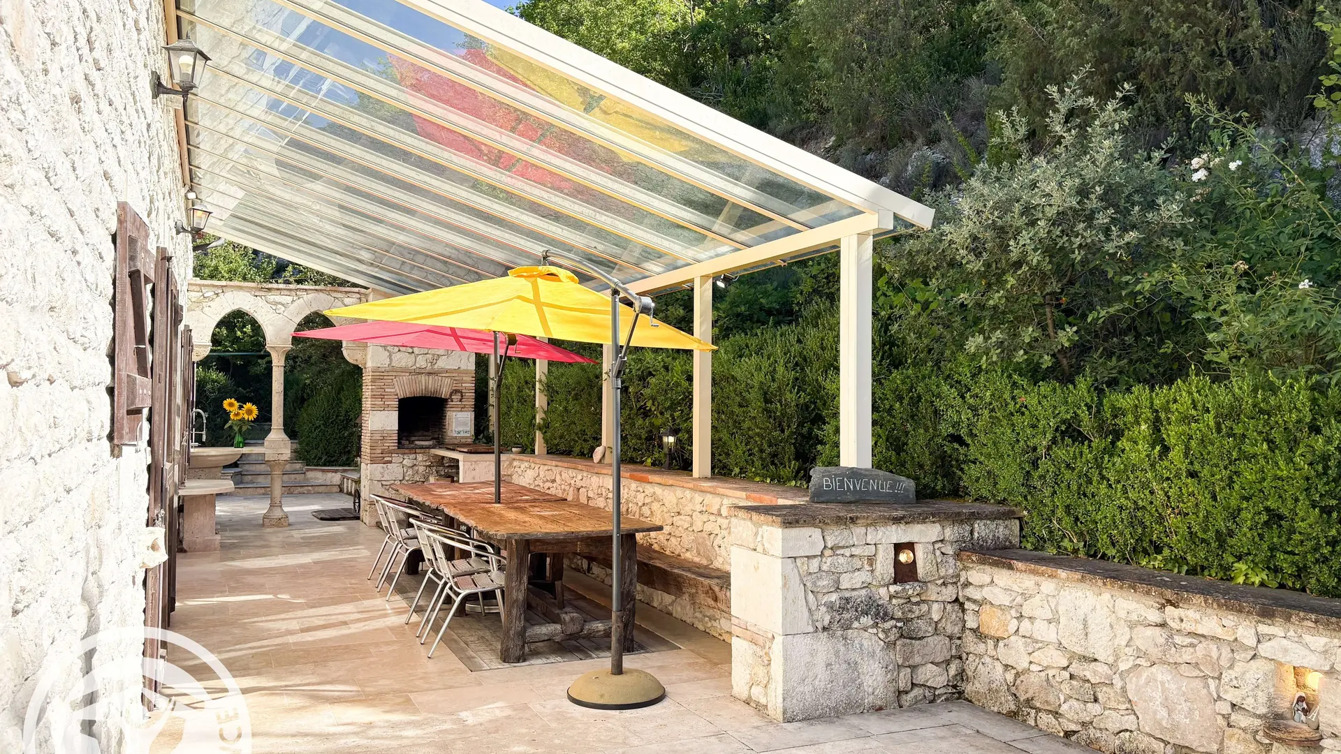 la grande terrasse couverte avec barbecue