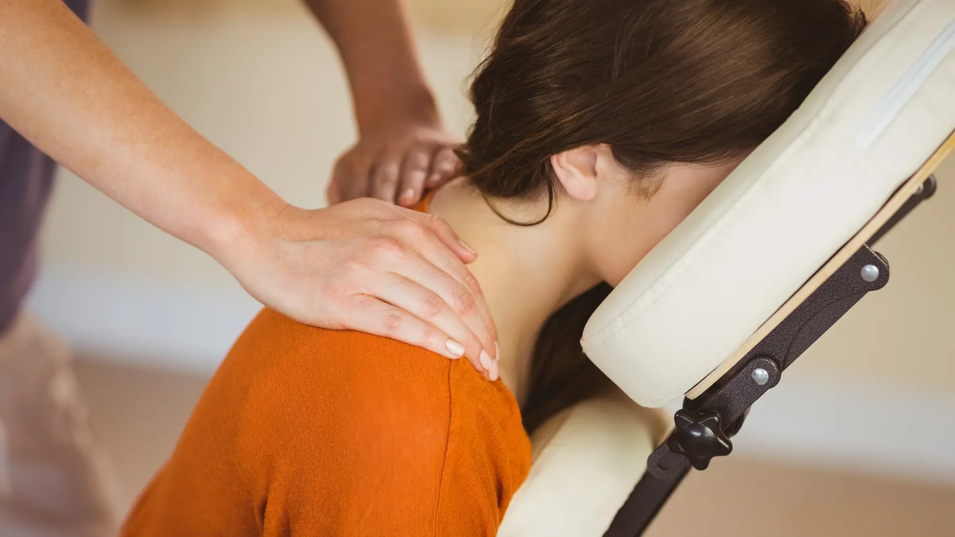 Young woman getting massage in chair