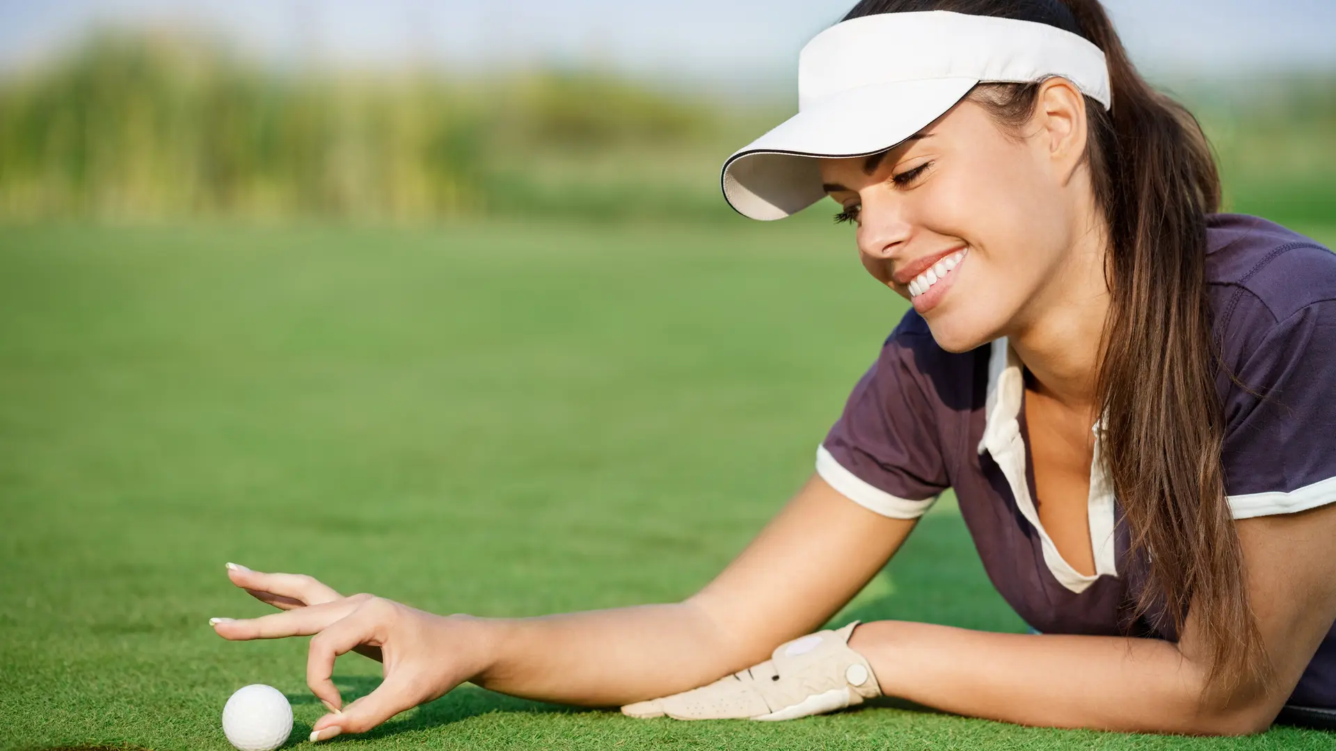 Woman pushing golf ball