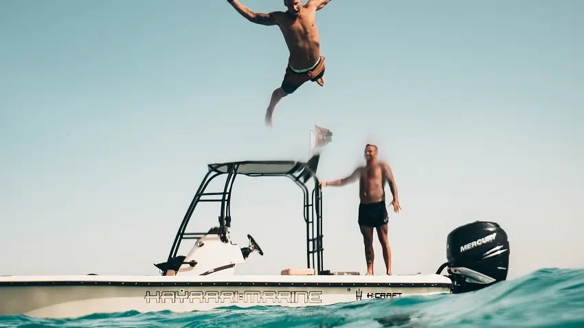 photo-of-man-jumping-from-boat-to-the-sea-1122462