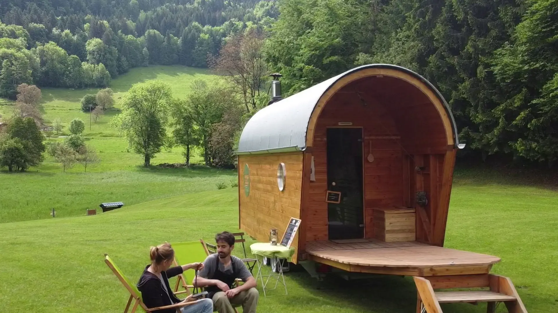 Marc et Caroline assis devant la Roulotte au Val de Tamié