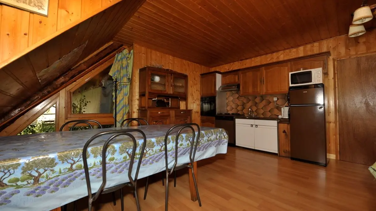 Fully equipped apartment living room, large dining table, kitchen, wooden furniture