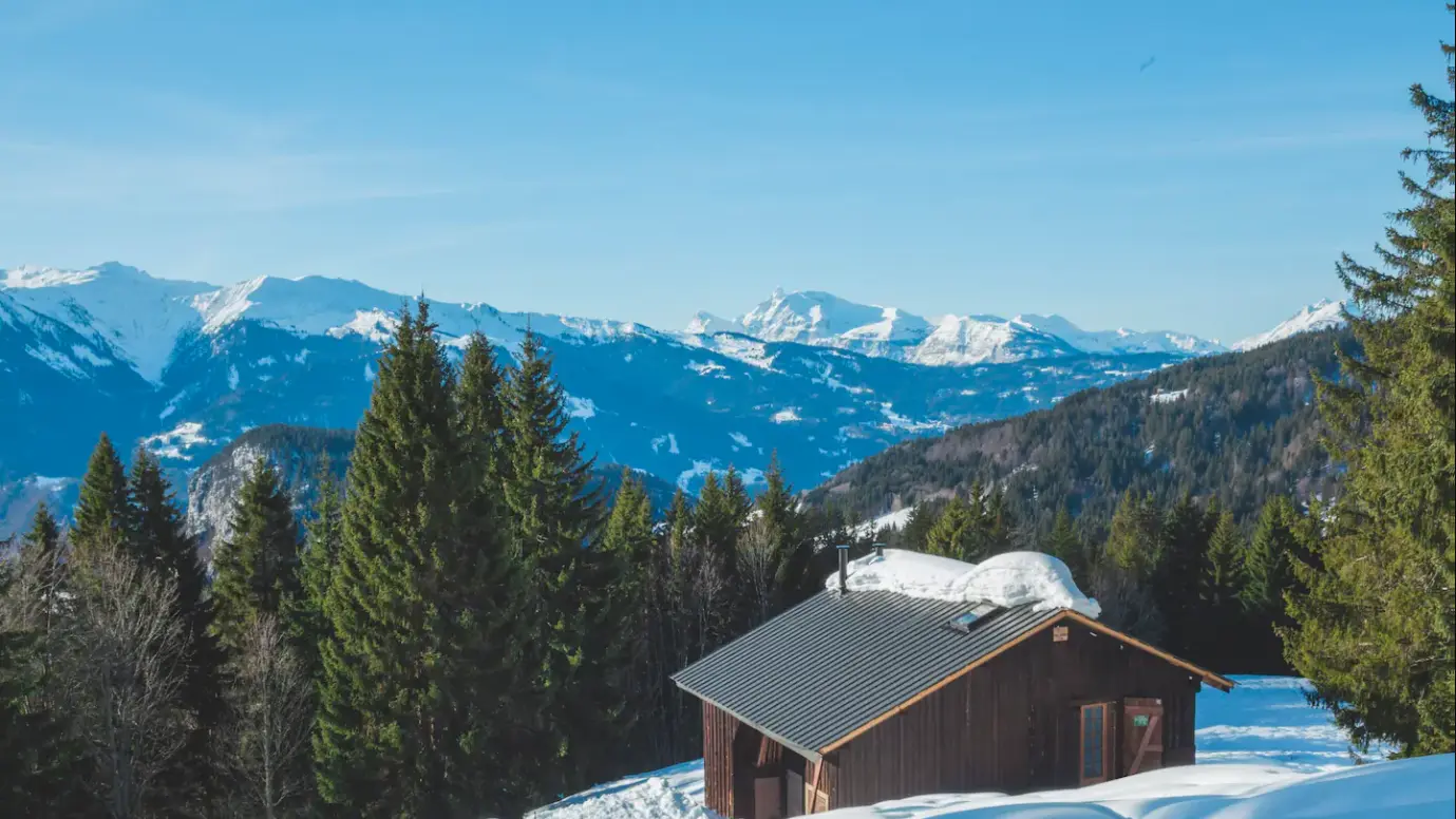 View of snowy chalet Mont Plaisir, ecological alpine accommodation in the Grand Massif mountains