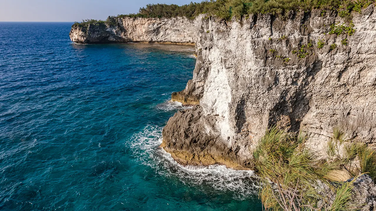 Deeply indented cliffs plunge into the Pacific Ocean