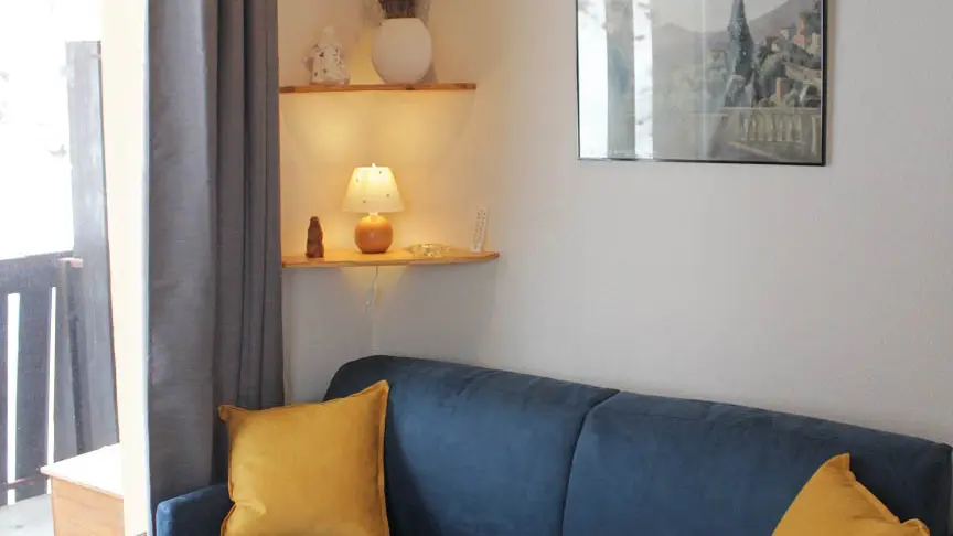 Bright and cozy living room with sofa, window and curtains